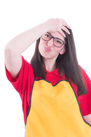 Young store seller with apron acting funny and holding head like she forget somethingの写真素材