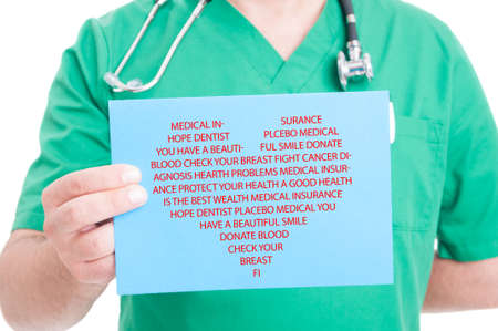 Closeup of paper with lots of medical words in heart shape in male doctor handの写真素材