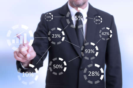 Man pressing digital button with increase graph on futuristic touchscreen monitor