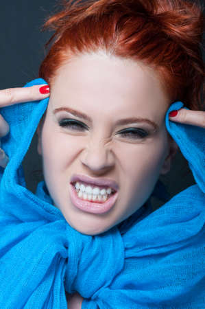 Woman model with crazy expression showing her teeth with angerの写真素材