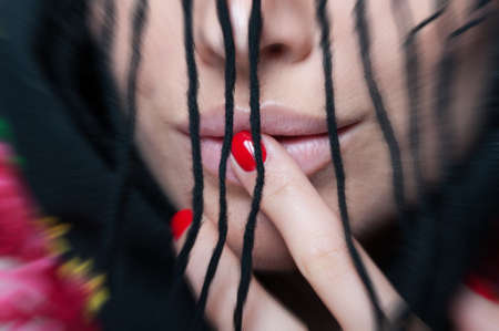 Sexy mouth of beautiful young woman in closeup wearing stylish scarfの写真素材