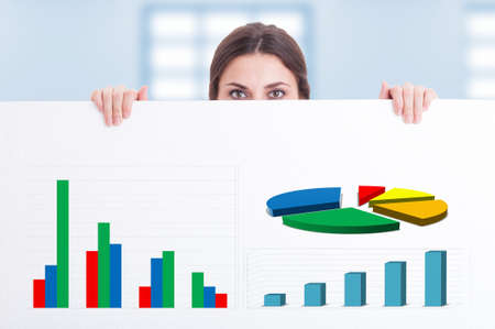 Female entrepreneur holding big cardboard with charts as successful investment concept
