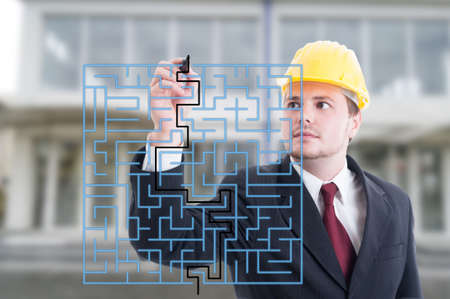 Handsome engineer solving a virtual puzzle with marker on digital screen