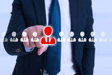 Businessman pointing on contact icon from futuristic screen for online conversationの写真素材