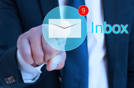 Businessman using futuristic interface to receive message or email notificationの写真素材