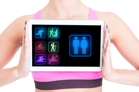 Sporty woman with fitness application on tablet pc isolated on white backgroundの写真素材