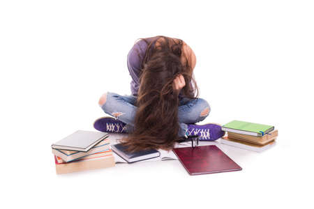 Worried and sad female student looking very exhauster after hard studyの写真素材