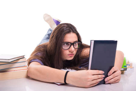 Portrait of girl student reading book isolated on white backgroundの写真素材