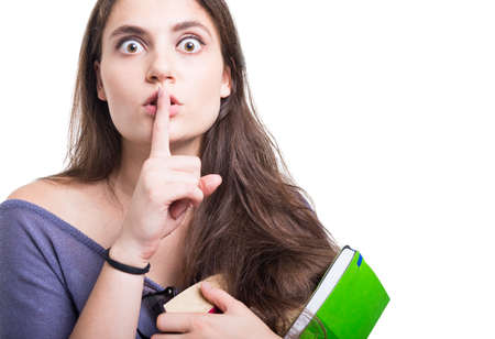 Beautiful young student doing silence or shush gesture on white background with copy text space