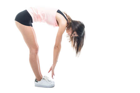Full body of fit girl wearing sportswear stretching isolated on white background with copyspace...
