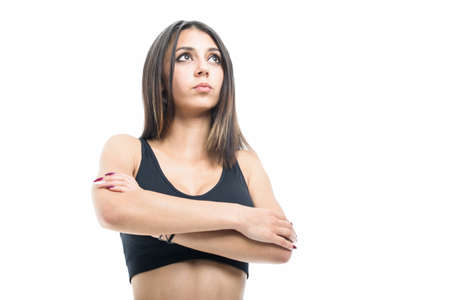 Portrait of fit girl posing in sport wear isolated on white background with copyspace advertising...