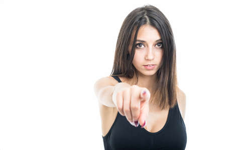 Portrait of fit girl pointing camera isolated on white background with copyspace advertising area