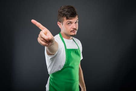 Portrait of attractive supermarket employer showing no or denial gesture on black background copyspace advertising areaの写真素材