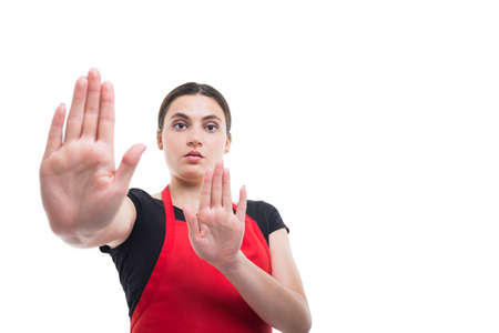 Portrait of young clerk doing stop sign with palms as refusal concept isolated on white background...
