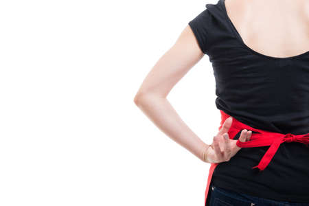 Girl seller tying a knot on apron behind her back on white background with copy text space