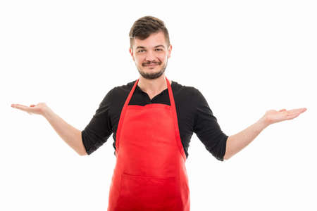 Supermarket employer holding or showing something in hands and smiling isolated on white background with copyspace advertising areaの写真素材
