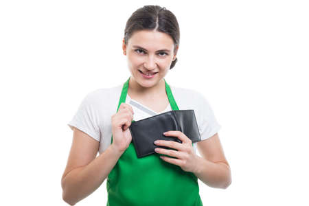 Beautiful employee girl taking out from wallet her credit card for electronic paymentの写真素材