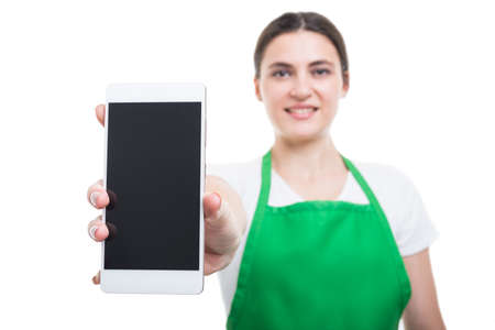 Smiling woman employer presenting a smartphone at the camera