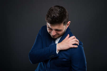 Business man suffering shoulder pain and having  medical problem