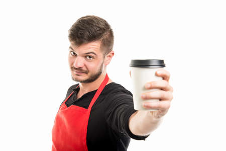 Supermarket employer handing takeaway coffee and smiling isolated on white backgroundの写真素材