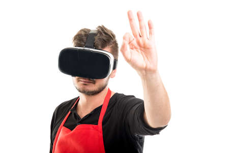 Male supermarket employer gesturing ok wearing vr goggles isolated on white background with copyspace advertising areaの写真素材