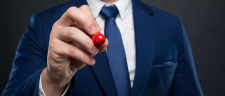 Hand of businessman writing on blank screen in closeup viewの写真素材