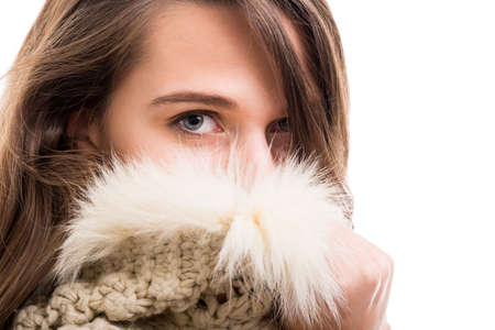 Hipster girl posing mysterious in close-up view on white backgroundの写真素材