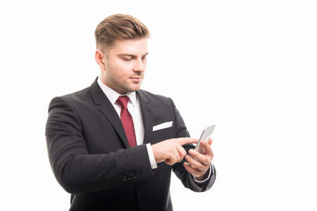 Portrait of business man browsing on smartphone isolated on white background with copyspace advertising areaの写真素材