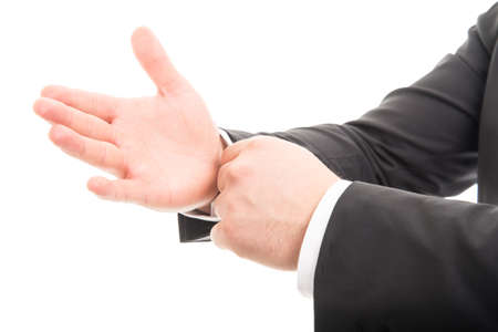 Close-up of business man hands arranging his sleeves isolated on white background