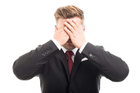 Handsome business man covering eyes like blind gesture isolated on white backgroundの写真素材