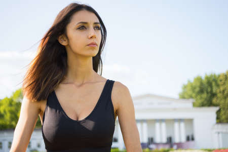 Brunette girl in sportwear exercising outside in a warm sunny dayの写真素材