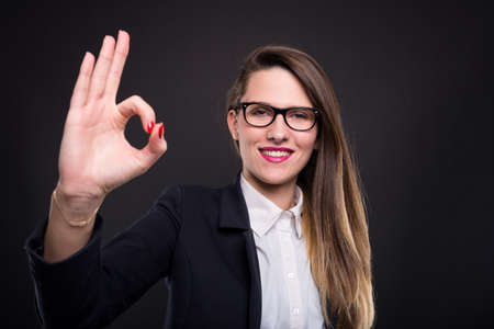 Professional young manager doing ok hand sign after finishing project with successの写真素材