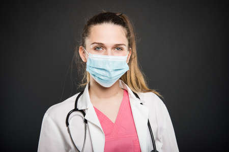 Young doctor portrait  posing with sterile mark on on black backgroundの写真素材