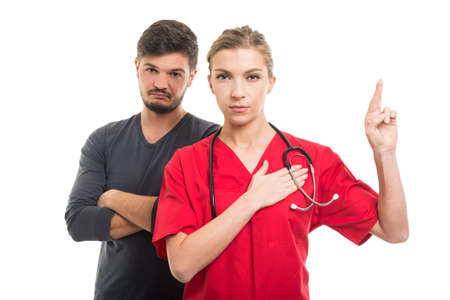 Male patient and female doctor taking fake oath isolated on white backgroundの写真素材