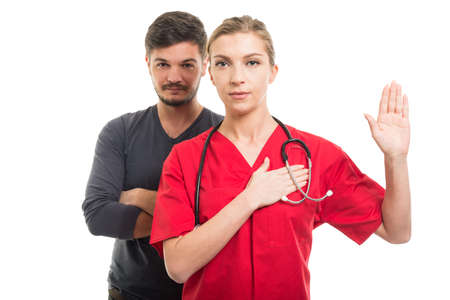 Male patient and female doctor taking oath  isolated on white backgroundの写真素材