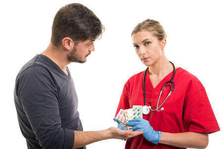 Male patient asking for tablets to female doctor isolated on white backgroundの写真素材