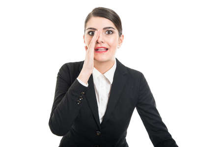 Portrait of beautiful female whispering something isolated on white background with copyspace advertising areaの写真素材