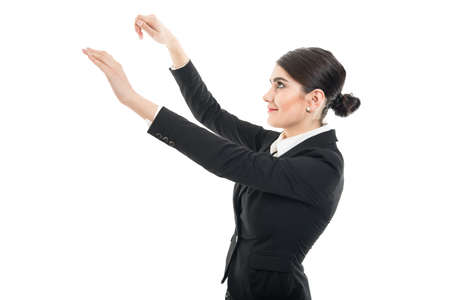 Beautiful female flight attendant gesturing luggage storage isolated on white backgroundの写真素材