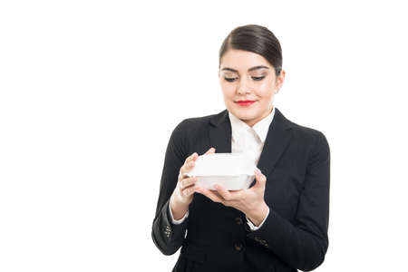 Portrait of beautiful stewardess holding lunch box ready to eat isolated on white background with copyspace advertising areaの写真素材