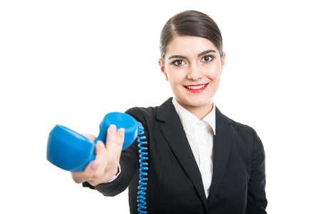 Beautiful stewardess handing big blue telephone receiver and smiling isolated on white backgroundの写真素材