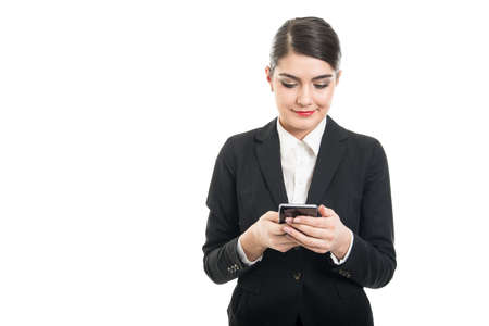 Beautiful stewardess browsing or texting on smartphone isolated on white background with copyspace advertising areaの写真素材