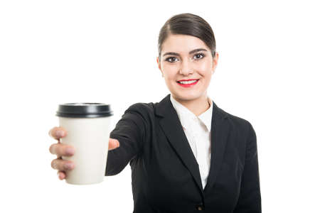 Portrait of beautiful stewardess offering takeaway coffee cup isolated on white backgroundの写真素材