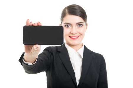 Selective focus of stewardess showing black smartphone screen isolated on white backgroundの写真素材