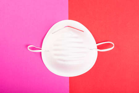 One face mask on pink and red background