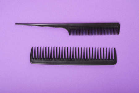 Two combs on purple background