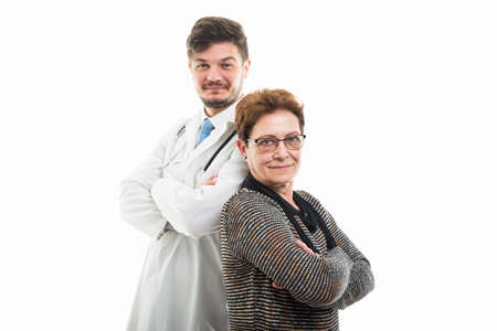 Male doctor and female senior patient standing back to back isolated on white background