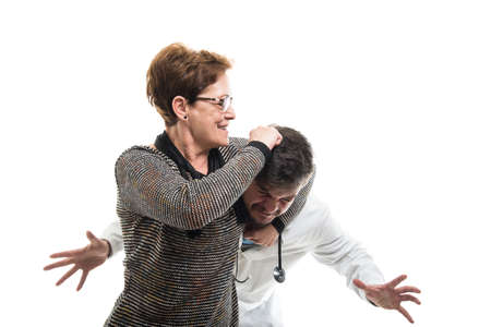Female senior patient playing with male doctor isolated on white background with copyspace...