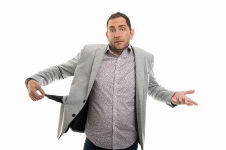 Portrait of business man showing empty pocket gesture isolated on white background