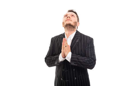 Portrait of business man looking up and showing praying gesture isolated on white background with copyspace advertising areaの写真素材