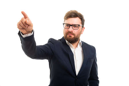 Portrait of business man pointing invisible touchscreen with right finger gesture isolated on white background with copyspace advertising areaの写真素材